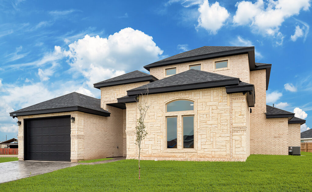Modern two-story home with stone exterior and landscaped front yard.